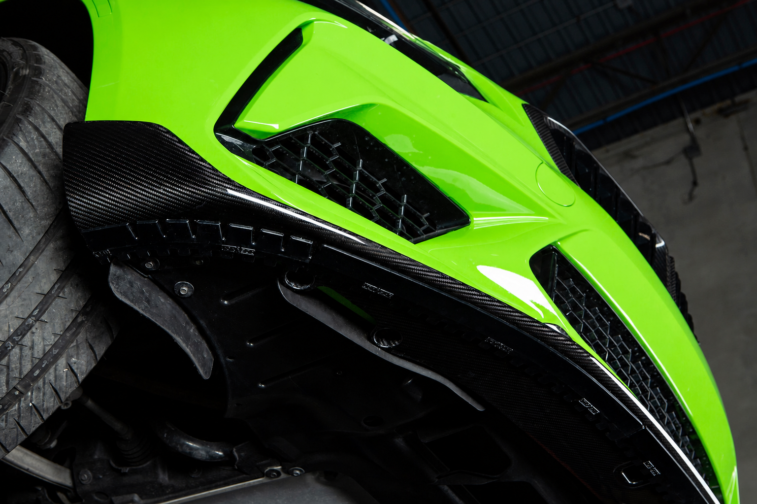 Acexxon lip protector installed beneath a carbon fiber front lip