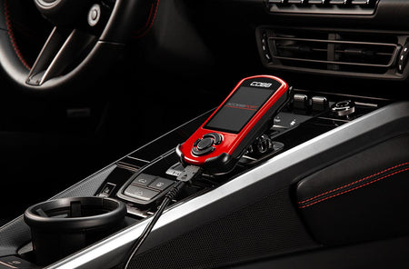 COBB Accessport V3 installed in a Porsche 911 992.1 center console, detail view