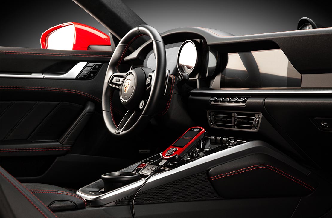 Porsche 911 992.1 cockpit with COBB Accessport V3 mounted on the center console