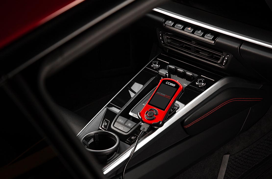 COBB Accessport V3 connected inside a Porsche 911 992.1, overhead console view