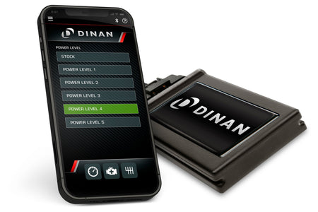 Dinan D440-0200 S58 PCU tuning module shown beside its smartphone app interface