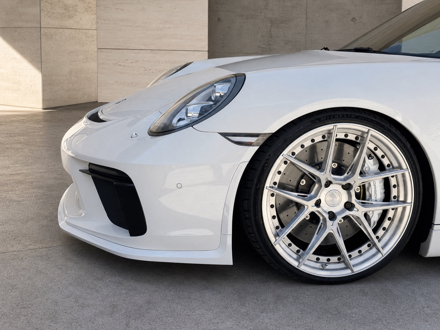 White EuroCustomsPR Porsche 911 991.2 at a functional ride height with a custom wheel and braking package