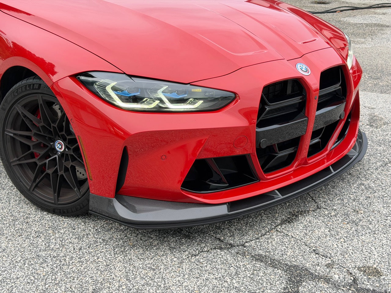 Red BMW G80 M3 with a carbon-fiber front lip and ECPR lower splitter
